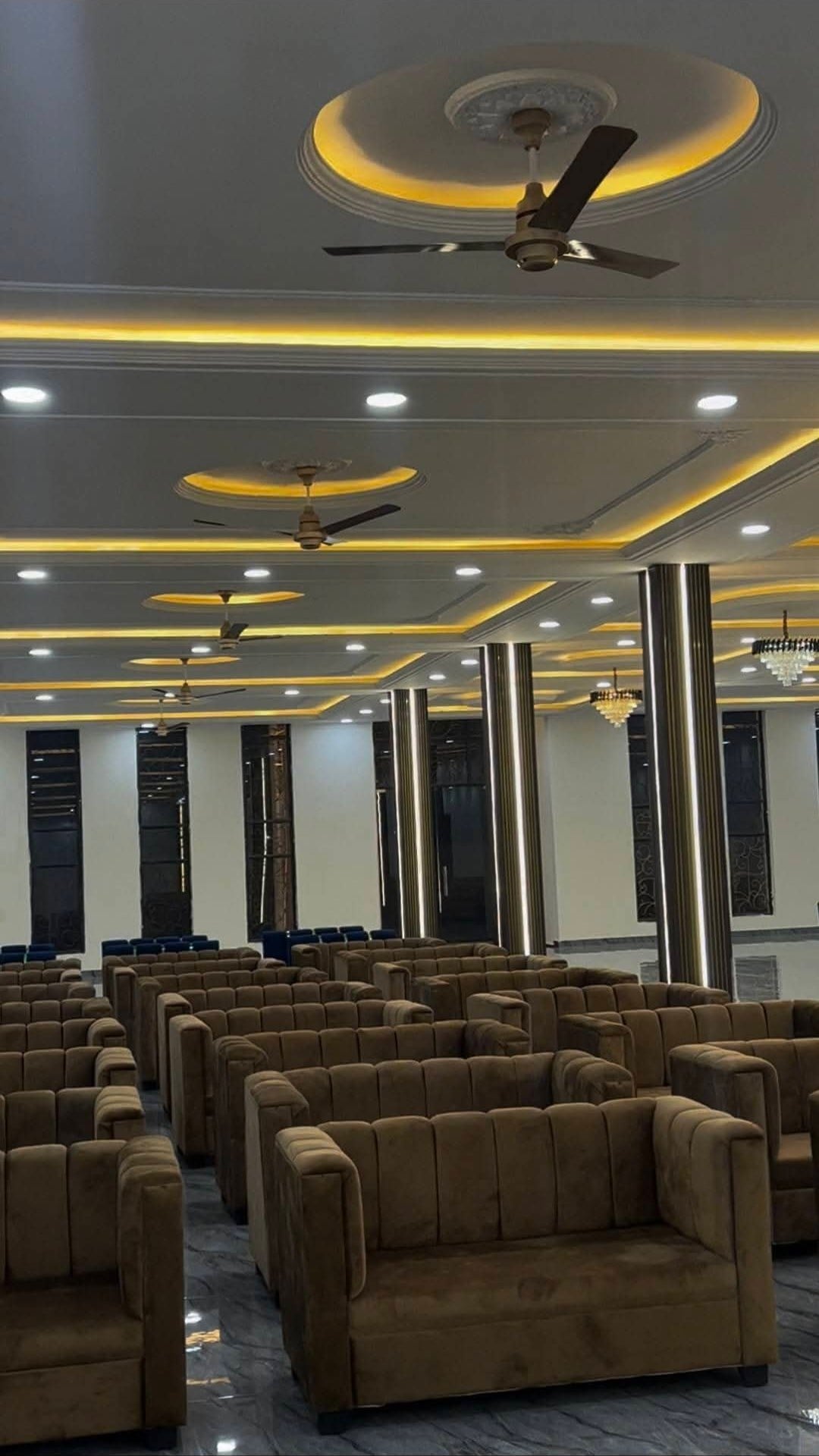 Indoor banquet hall seating area arranged with sofa seating and warm ceiling lighting